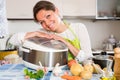 Woman cooking with multicooker