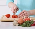 Woman cooking in new kitchen making healthy food with vegetables. Royalty Free Stock Photo