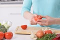 Woman cooking in new kitchen making healthy food with vegetables. Royalty Free Stock Photo