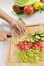 Woman cooking in new kitchen making healthy food with vegetables. Royalty Free Stock Photo