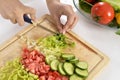 Woman cooking in new kitchen making healthy food with vegetables. Royalty Free Stock Photo