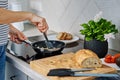 Woman cooking omelet , use induction stove and frying pan Royalty Free Stock Photo