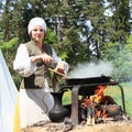 Woman cooking on opened fire