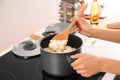 Woman cooking rice in kitchen Royalty Free Stock Photo