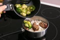 Woman cooking rice with meat and broccoli in kitchen Royalty Free Stock Photo