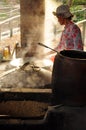 Woman cooking rice paste to make rice noodles, vietnam