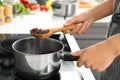 Woman cooking rice in saucepan on stove Royalty Free Stock Photo