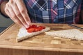 Woman cooking sandwiches toast with a fresh berries in the kitchen