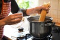 Woman cooking spaghetti on stove in kitchen, closeup Royalty Free Stock Photo