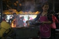 A woman cooking on a stall in a night market in Hanoi