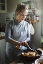 Woman cooking steak in the kitchen