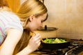 Woman cooking stir fry frozen vegetable on pan Royalty Free Stock Photo