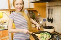 Woman cooking stir fry frozen vegetable on pan Royalty Free Stock Photo