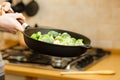 Woman cooking stir fry frozen vegetable on pan Royalty Free Stock Photo