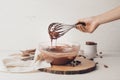 Woman cooking tasty melted chocolate on table in kitchen Royalty Free Stock Photo