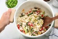 Woman cooking tasty rice with vegetables in saucepan Royalty Free Stock Photo