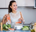 Woman cooking trout in steamer Royalty Free Stock Photo