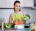 Woman cooking trout in steamer Royalty Free Stock Photo