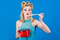 Woman with cooking utensils in kitchen. Retro style housewife with saucepan and spoon. Cuisine, culinary, household