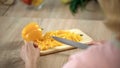 Woman cooking vegetable salad in kitchen, yellow pepper on chopping board, diet