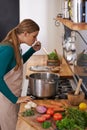 Woman, cooking and vegetable at stove or tasting meal in kitchen for vegetarian dinner, nutrition or raw ingredients Royalty Free Stock Photo