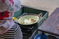 Woman cooking Vietnamese crusty shrimp pancake at hawker- Banh Xeo