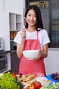 Woman cooking and whisking eggs in a bowl in kitchen room Royalty Free Stock Photo