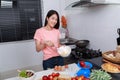Woman cooking and whisking eggs in a bowl in kitchen Royalty Free Stock Photo