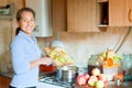 Woman cooks applesauce jam