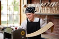 Woman cooks dough on machine for making pasta Royalty Free Stock Photo