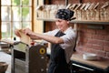 Woman cooks dough on machine for making pasta Royalty Free Stock Photo