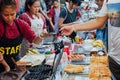 Woman cooks and sells waffles