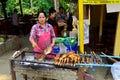 Woman cooks on the side on the street