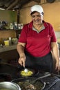 Woman cooks traditional Costa Rican lunch of Gallo Pinto