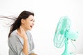 Woman cooling herself by electric fan Royalty Free Stock Photo