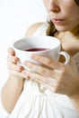 Woman cooling hot drink
