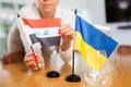 Woman coordinator setting flags of Ukraine and Iraq on negotiating table