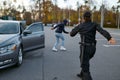 Woman cop running after hooded car thief Royalty Free Stock Photo