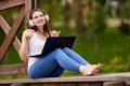 Woman in cordless headphones listens to music outdoors. Royalty Free Stock Photo