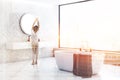 White wood bathroom corner, tub and sink, woman Royalty Free Stock Photo