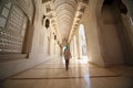 Woman in corridor inside Grand Mosque in Oman Royalty Free Stock Photo