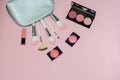 Woman cosmetic bag, make up beauty products on pink background. Makeup brushes, pink lipstick and rouge palettes. Decorative cosme Royalty Free Stock Photo