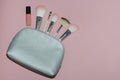 Woman cosmetic bag, make up beauty products on pink background. Makeup brushes and pink lipstick. Top view, flatlay. Decorative co Royalty Free Stock Photo