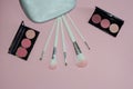 Woman cosmetic bag, make up beauty products on pink background. Makeup brushes and rouge palettes. Decorative cosmetics. Top view, Royalty Free Stock Photo