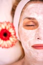 Woman with cosmetic face mask for evening of roughness and imperfections on the skin