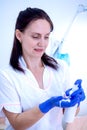 Woman cosmetician in gloves and with cream