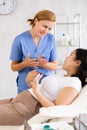 Woman cosmetician talking with woman before procedure in aesthetic cosmetology clinic