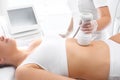 Belly lift. A woman in a cosmetics clinic during a firming massage on the skin of the abdomen Royalty Free Stock Photo