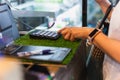 Woman costomer enters the amount into the cash register in cafe. Royalty Free Stock Photo