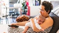 Woman on the couch with her baby Royalty Free Stock Photo